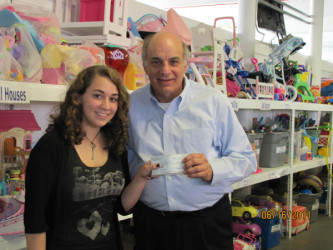 Independently United founder Kaityn Kenny presents Jim Stevens wtih a check for $700 - the proceeds from their debut "pop-up gallery" auction. 