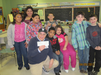 Students present GiftsToGive CEO Jim Stevens with a check for $382.96. 