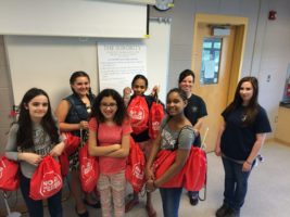 Donating thank you bags with food and toys that they collected at the school for the humane society